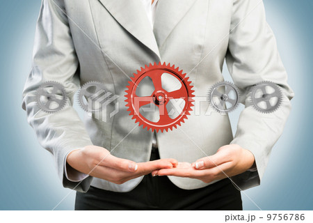 business woman holds up a mechanism of gears business woman holds up a mechanism of gears 9756786