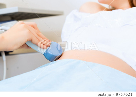 close-up of hands and abdominal ultrasound scanner 9757021