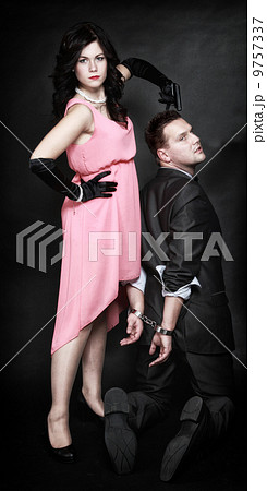 attractive couple sexy woman with gun gangster in handcuffs attractive couple sexy woman with gun gangster in handcuffs 9757337