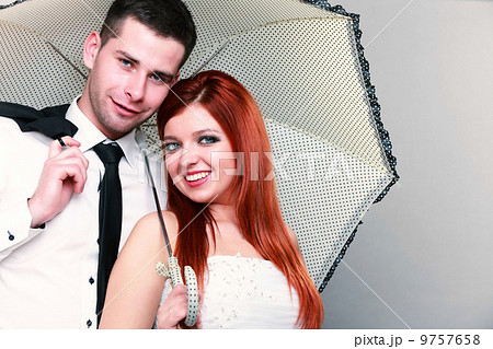 Happy married couple bride groom on gray background 9757658