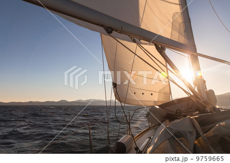 Sailboat at sunset ocean Sailboat at sunset ocean 9759665