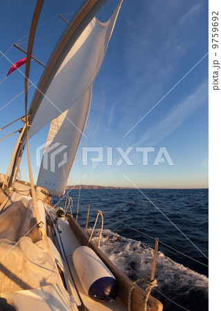 Sailboat during the regatta at sunset ocean Sailboat during the regatta at sunset ocean 9759692