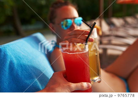 Couple clinking glasses with cocktails Couple clinking glasses with cocktails 9765778