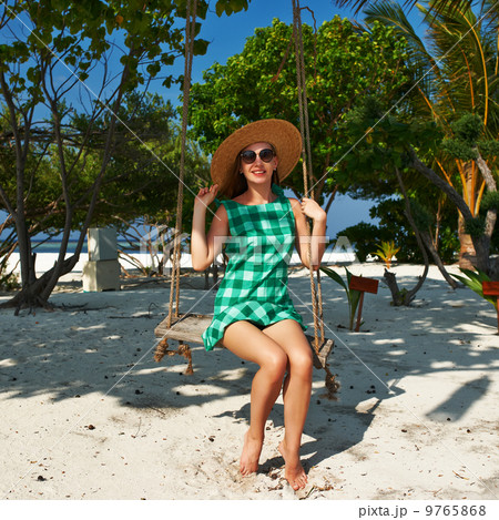 Woman in green dress at beach Woman in green dress at beach 9765868