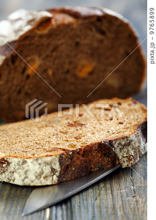 Rye bread with dried apricots close-up. 9765899