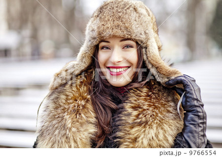 Girl smiling in fur hat and coat 9766554