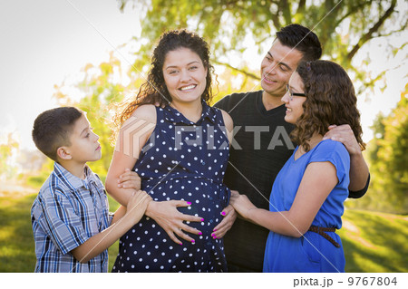 Happy Attractive Hispanic Family With Their Pregnant Mother Outd 9767804