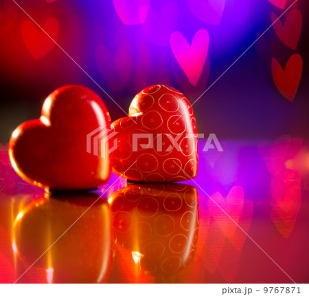 Couple of Valentines Red Hearts over Abstract Purple Background 9767871
