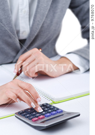 Hands working on the calculator Hands working on the calculator 9768070
