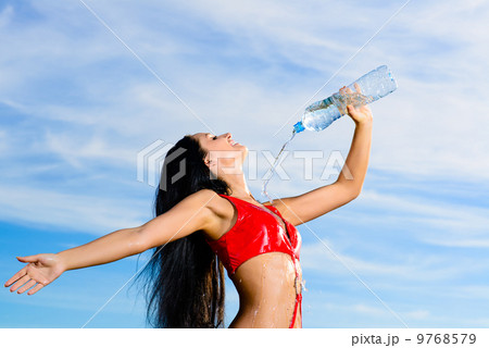 sport girl in red uniform with a bottle of water sport girl in red uniform with a bottle of water 9768579