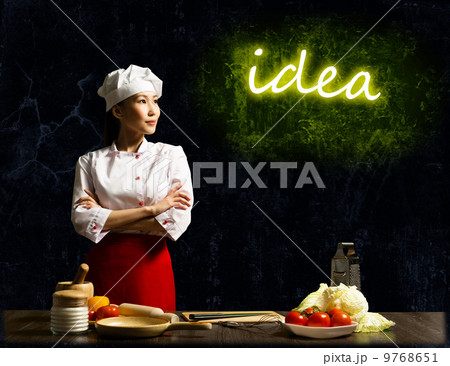 Asian female chef looking at the glowing idea Asian female chef looking at the glowing idea 9768651