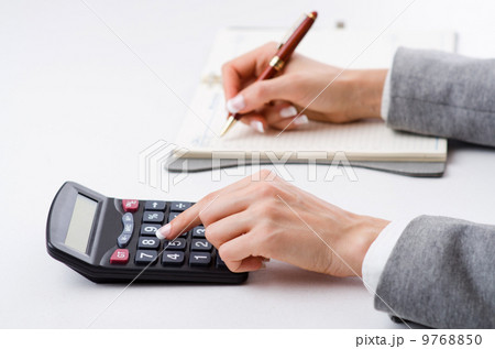 Hands working on the calculator Hands working on the calculator 9768850