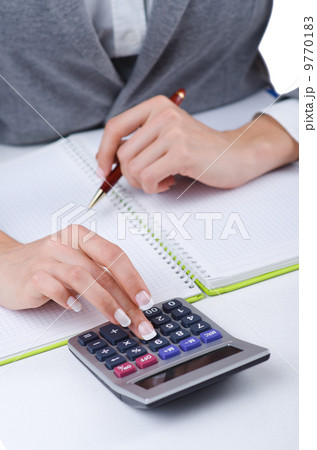 Hands working on the calculator Hands working on the calculator 9770183