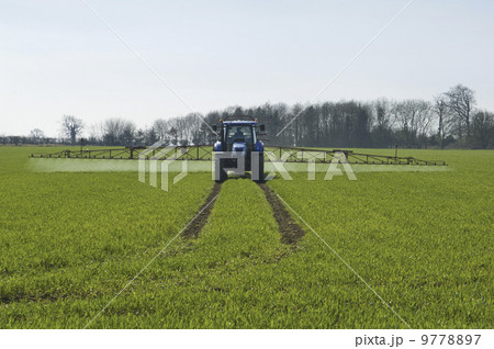 Tractor and crop-sprayer in field. Tractor and crop-sprayer in field. 9778897