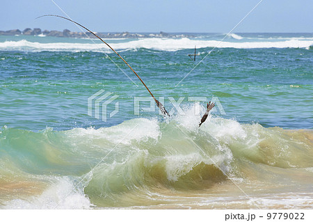 Fisherman in wave 9779022