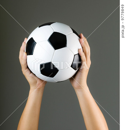 Hand holding soccer ball 9779849