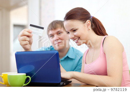 couple paying by credit card in internet store 9782119