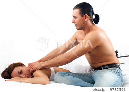 Husband massaging the behind of his woman in bed at home 9782541