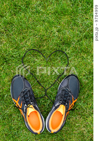 Sneakers on grass with heart Sneakers on grass with heart 9784999