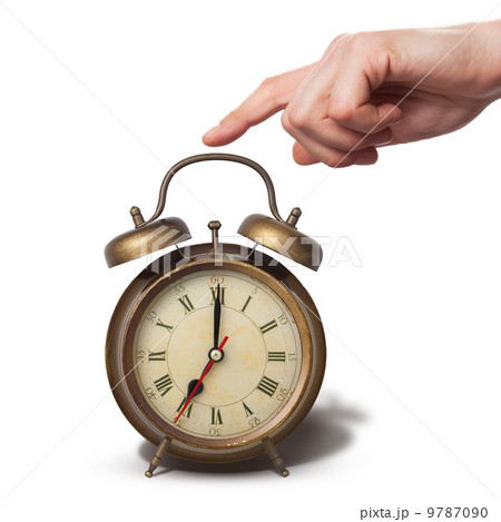 Brown old style alarm clock with hand isolated on white Brown old style alarm clock with hand isolated on white 9787090