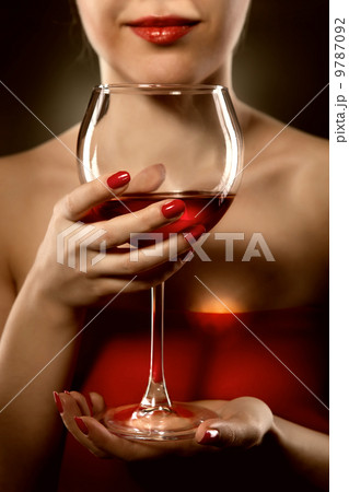 woman in red holding wine glass and smiles 9787092