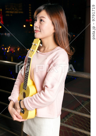 Pretty Asian woman with ukelele 9791719