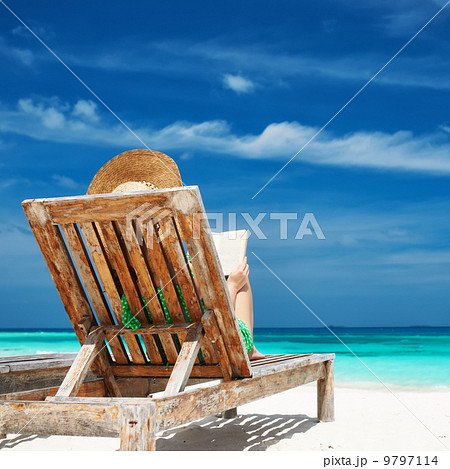 Young woman reading a book at beach 9797114