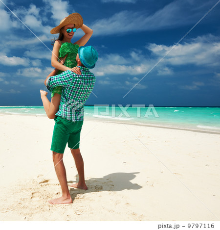 Couple in green on a beach at Maldives Couple in green on a beach at Maldives 9797116