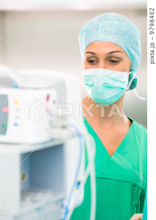 Doctor or nurse in operating room on heart monitor 9798402