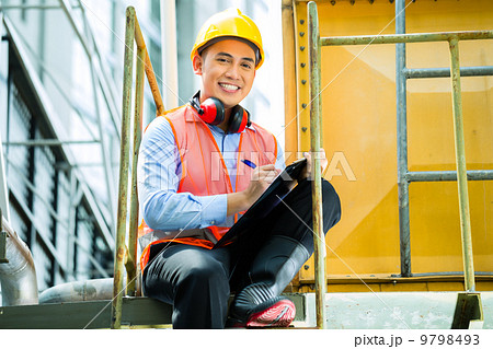 Asian Indonesian construction worker on building site 9798493