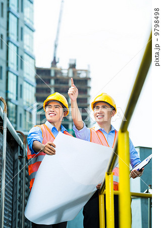 Asian Indonesian construction workers on building site 9798498