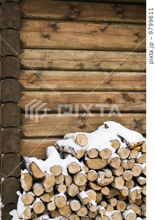 Birch fire wood at a wall of the house in winter Birch fire wood at a wall of the house in winter 9799611