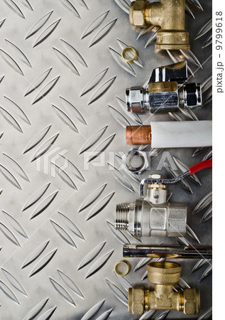 Plumbing inlet pipe valve on a metal surface 9799618