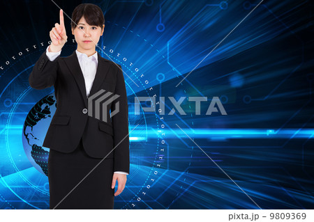 Composite image of focused businesswoman pointing Composite image of focused businesswoman pointing 9809369