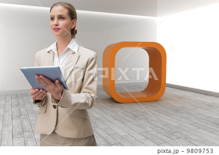 Composite image of pensive stylish businesswoman holding tablet 9809753