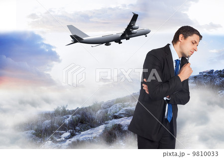 Composite image of thinking businessman holding pen Composite image of thinking businessman holding pen 9810033