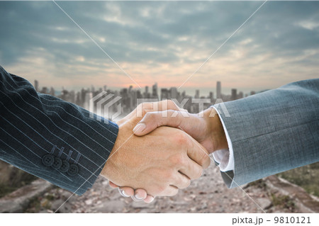 Composite image of business handshake 9810121