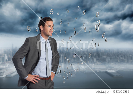 Composite image of smiling businessman with hands on hips Composite image of smiling businessman with hands on hips 9810265
