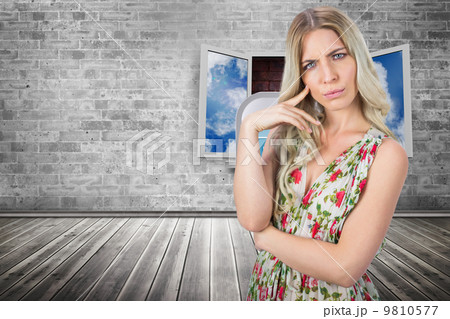 Composite image of frowning pretty blonde wearing flowered dress 9810577