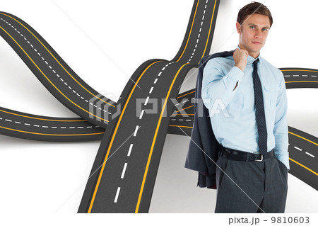 Composite image of serious businessman holding his jacket 9810603