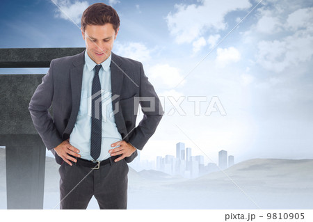 Composite image of cheerful businessman standing with hands on h Composite image of cheerful businessman standing with hands on h 9810905