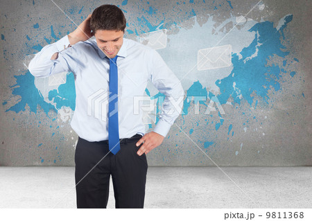 Composite image of thinking businessman scratching head 9811368