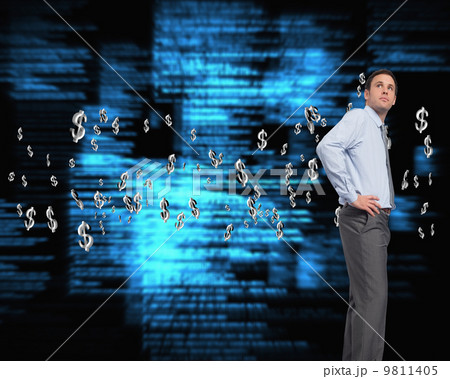 Composite image of serious businessman with hand on hip 9811405