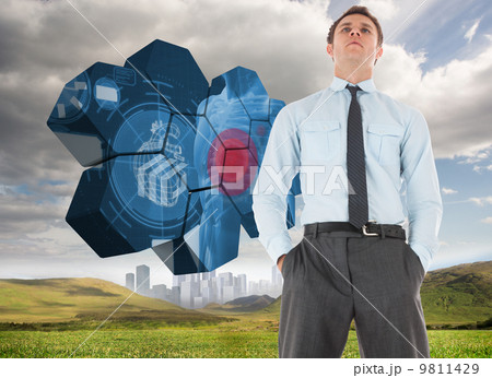 Composite image of serious businessman standing with hands in po 9811429