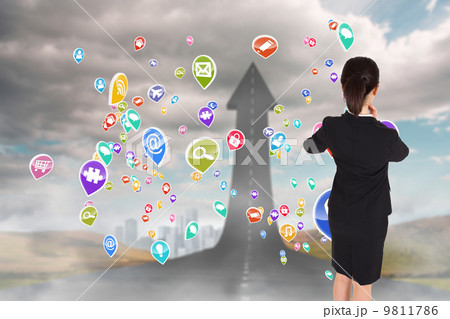 Composite image of thoughtful businesswoman pointing 9811786
