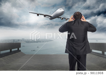 Composite image of stressed businessman with hands on head Composite image of stressed businessman with hands on head 9811908