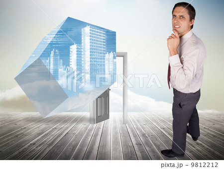 Composite image of thinking businessman touching his chin 9812212