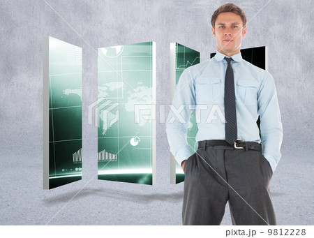 Composite image of serious businessman standing with hands in po 9812228