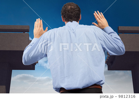 Composite image of businessman posing with arms raised 9812316