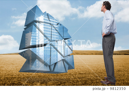 Composite image of serious businessman with hand on hip Composite image of serious businessman with hand on hip 9812350